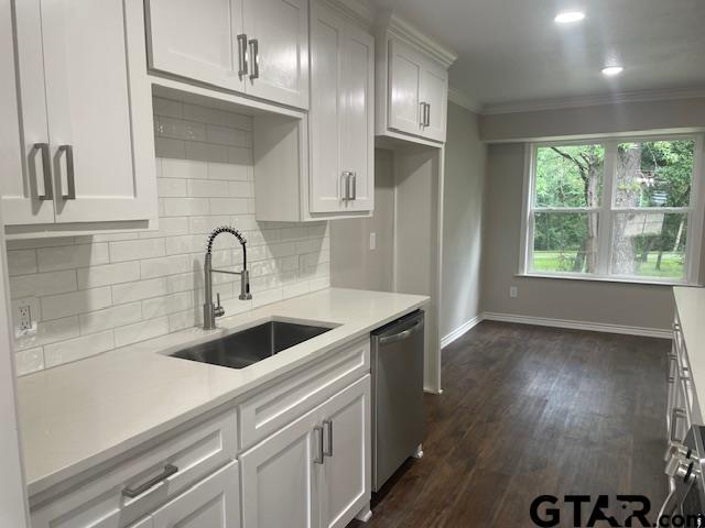 110 Alpine Dr, Tyler, TX 75701 - kitchen with dishwasher, light countertops, tasteful backsplash, ornamental molding, and white cabinets