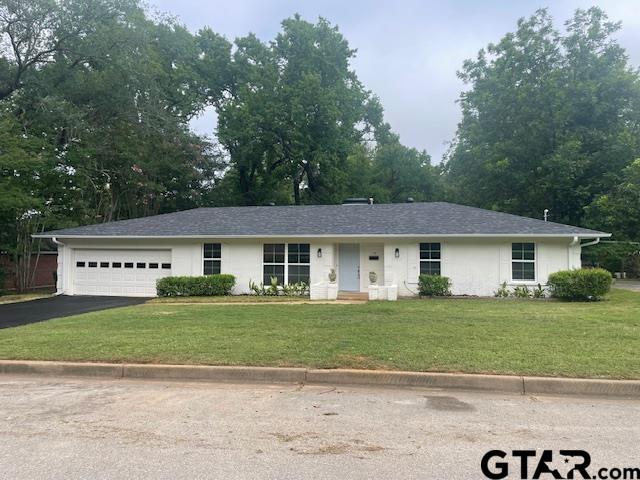 110 Alpine Dr, Tyler, TX 75701 - ranch-style house with driveway, a garage, and a front lawn