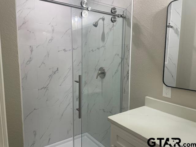 110 Alpine Dr, Tyler, TX 75701 - full bathroom featuring a marble finish shower, vanity, and a textured wall