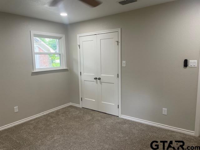 110 Alpine Dr, Tyler, TX 75701 - unfurnished bedroom featuring carpet, a ceiling fan, and a closet