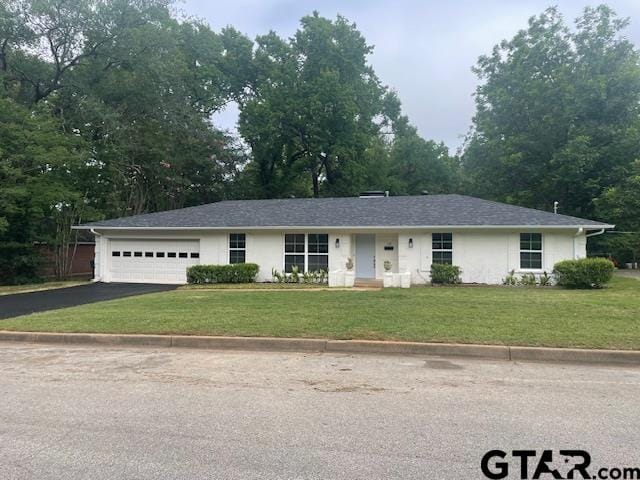 110 Alpine Dr, Tyler, TX 75701 - ranch-style home with asphalt driveway, an attached garage, and a front yard