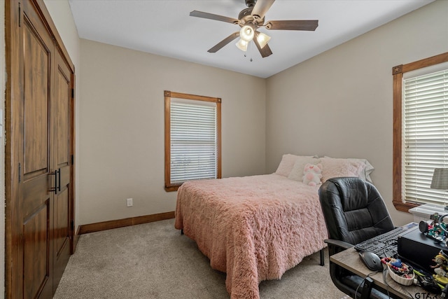 carpeted bedroom with ceiling fan and a closet