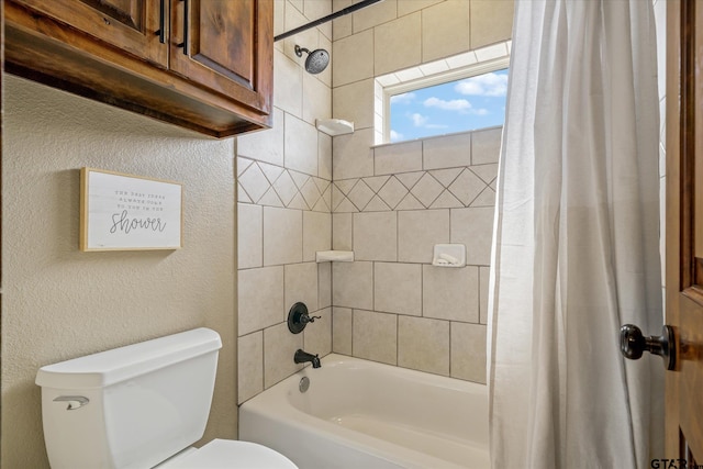 bathroom featuring shower / bath combo with shower curtain and toilet