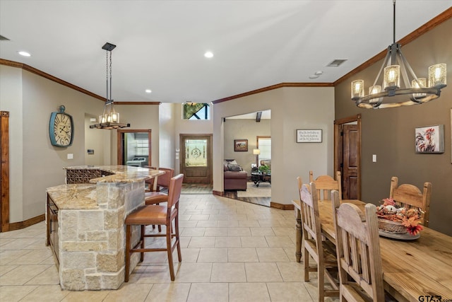 dining space featuring light tile patterned flooring, crown molding, and a chandelier