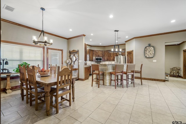 dining area with a notable chandelier, ornamental molding, and light tile patterned floors