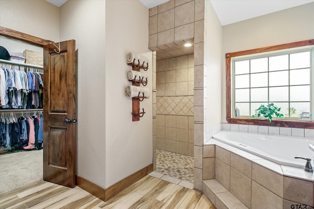 bathroom with shower with separate bathtub and hardwood / wood-style floors