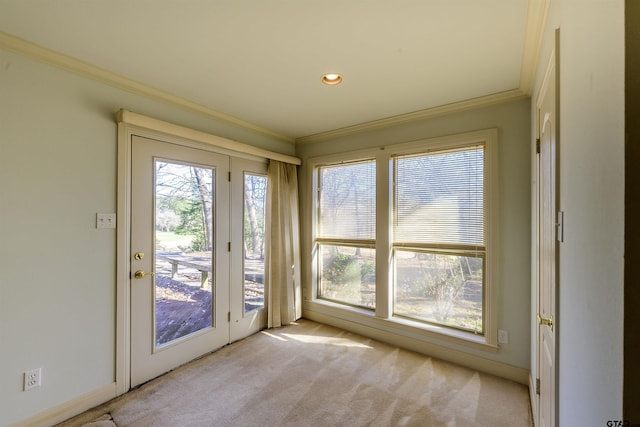 doorway featuring light colored carpet and crown molding