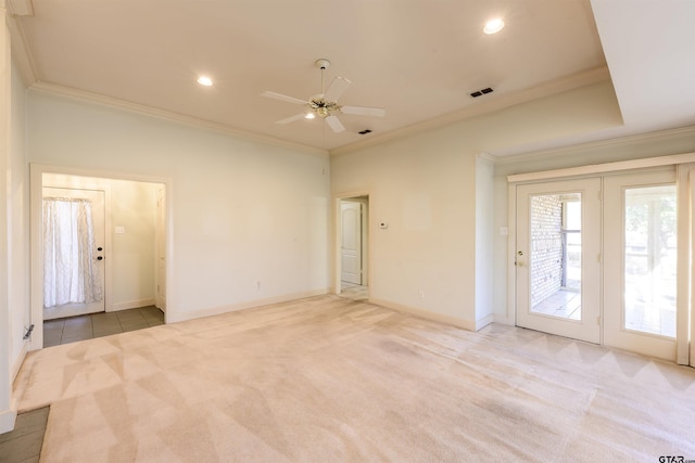 empty room with ceiling fan, light colored carpet, and crown molding