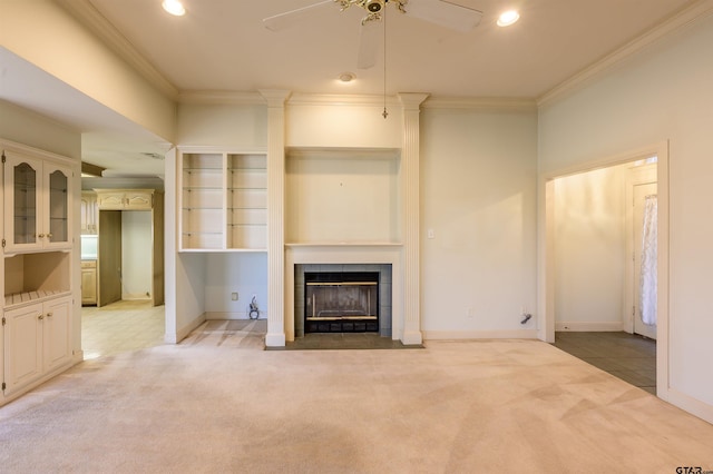 unfurnished living room with crown molding, light carpet, and a tile fireplace