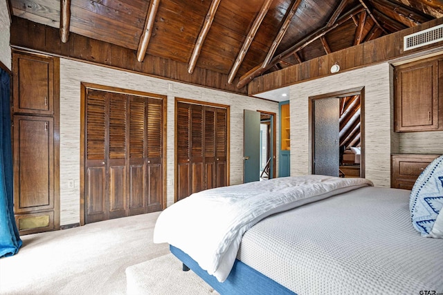 carpeted bedroom with visible vents, multiple closets, high vaulted ceiling, beamed ceiling, and wooden ceiling