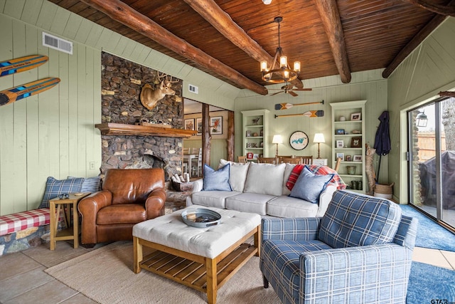 living room with visible vents, beam ceiling, a notable chandelier, a stone fireplace, and wood ceiling