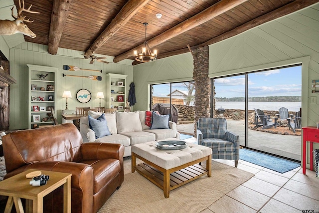 living area featuring a water view, beamed ceiling, wood walls, wooden ceiling, and light tile patterned flooring