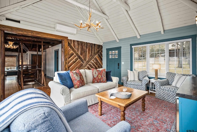 living room with visible vents, a wall mounted AC, lofted ceiling with beams, wood finished floors, and an inviting chandelier