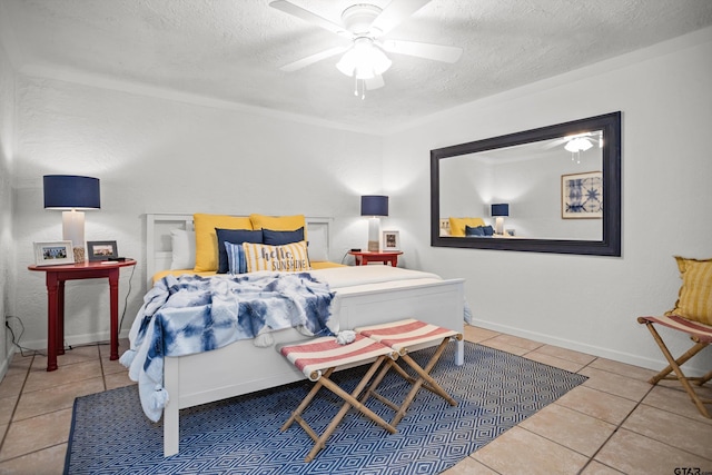 tiled bedroom featuring baseboards, a textured ceiling, and a ceiling fan