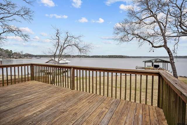 wooden terrace featuring a dock and a water view