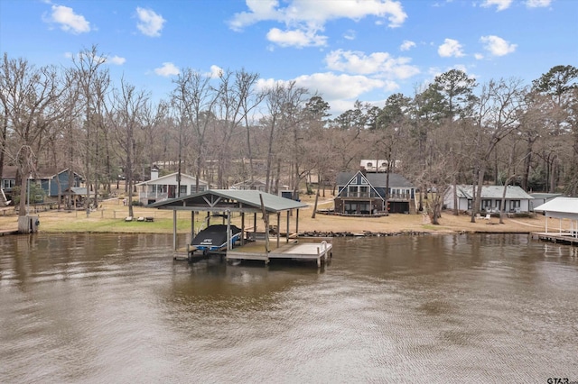 dock area featuring boat lift and a water view