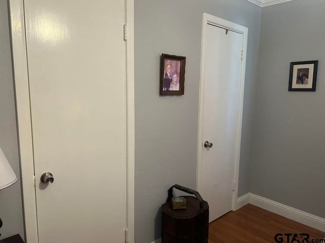 interior space with hardwood / wood-style floors and crown molding