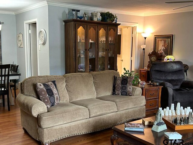 living room with ornamental molding, hardwood / wood-style floors, and ceiling fan