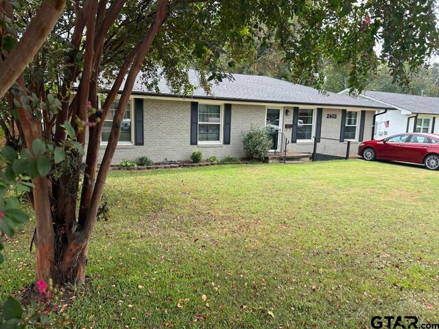 ranch-style home with a front lawn