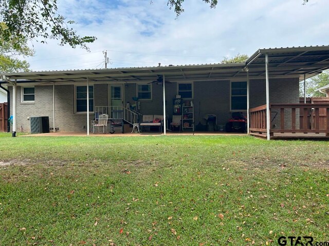 back of property featuring a wooden deck, a patio area, a yard, and cooling unit