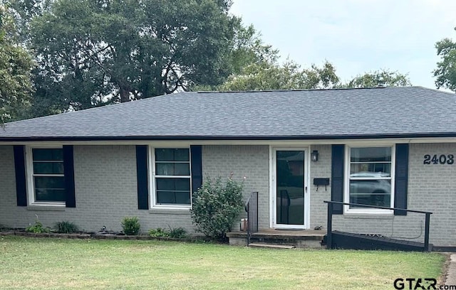 ranch-style home featuring a front yard