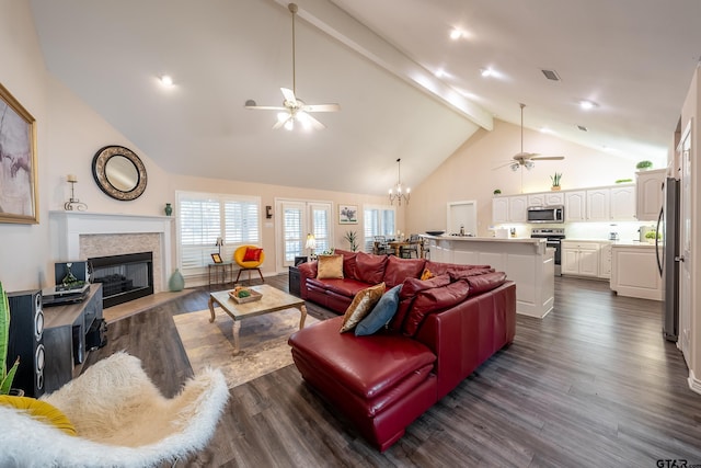 living room with beam ceiling, dark hardwood / wood-style flooring, high vaulted ceiling, and ceiling fan with notable chandelier