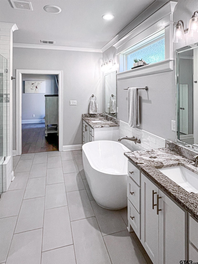 9035 Shallow Cv, Tyler, TX 75703 - full bath with two vanities, crown molding, a freestanding tub, a shower, and tile patterned floors