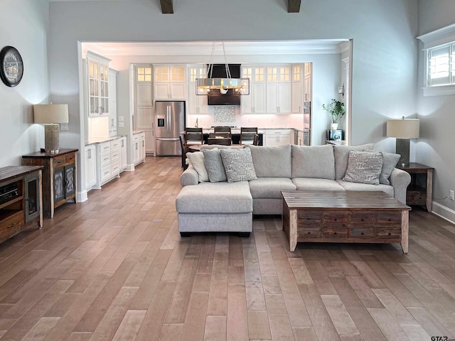 9035 Shallow Cv, Tyler, TX 75703 - living area with light wood-type flooring and a chandelier