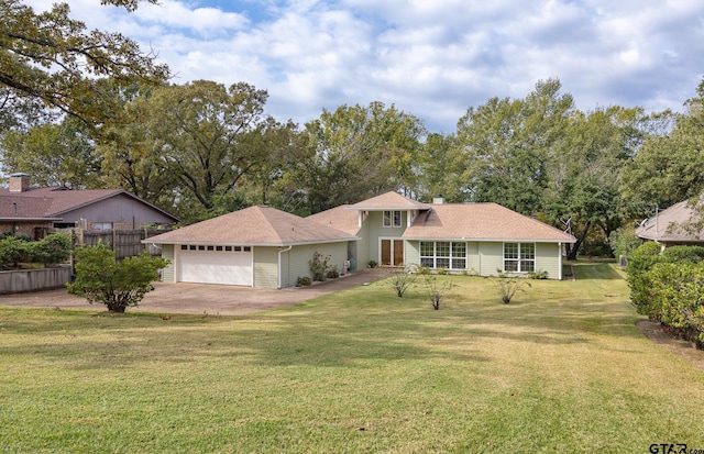 view of front of property featuring a garage and a front lawn