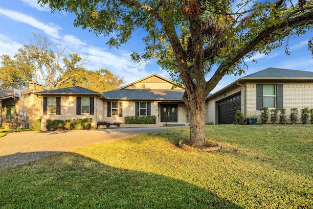 single story home featuring a garage and a front lawn