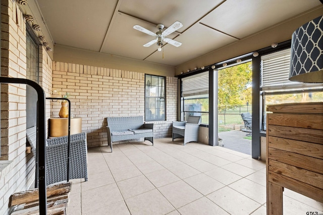 unfurnished sunroom with ceiling fan