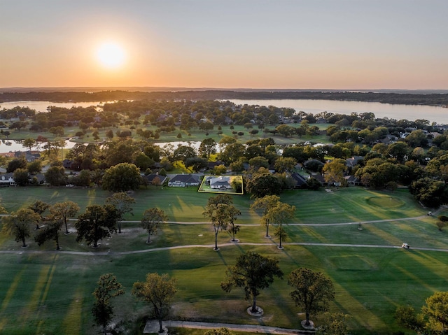 aerial view at dusk featuring a water view