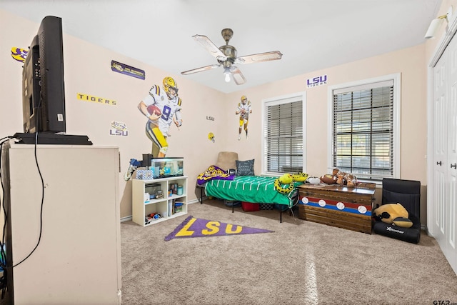 bedroom featuring ceiling fan and a closet