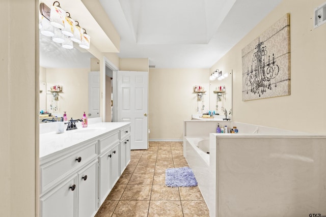 bathroom with tile patterned floors, a raised ceiling, a tub to relax in, and vanity