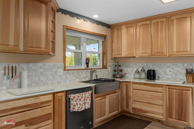 kitchen with dishwashing machine, a sink, light countertops, light brown cabinetry, and backsplash