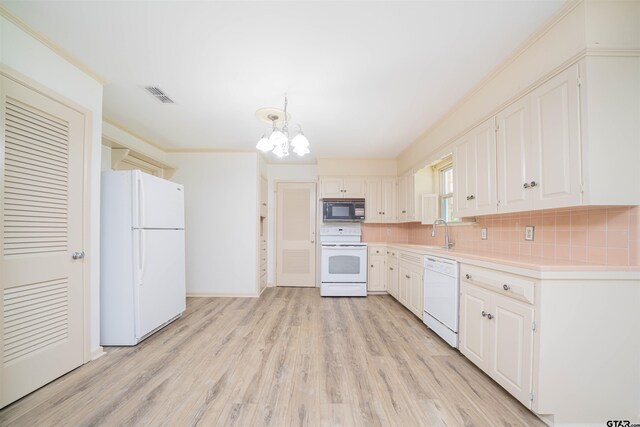 2504 Pounds Ave, Tyler, TX 75701 - kitchen featuring white appliances, a chandelier, light countertops, tasteful backsplash, and a sink