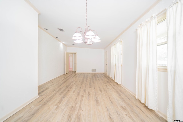 2504 Pounds Ave, Tyler, TX 75701 - empty room with a chandelier, light wood finished floors, and crown molding