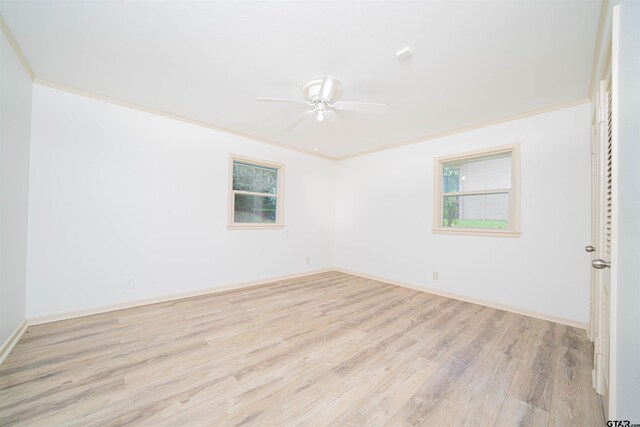 2504 Pounds Ave, Tyler, TX 75701 - empty room with wood finished floors, plenty of natural light, ceiling fan, crown molding, and baseboards