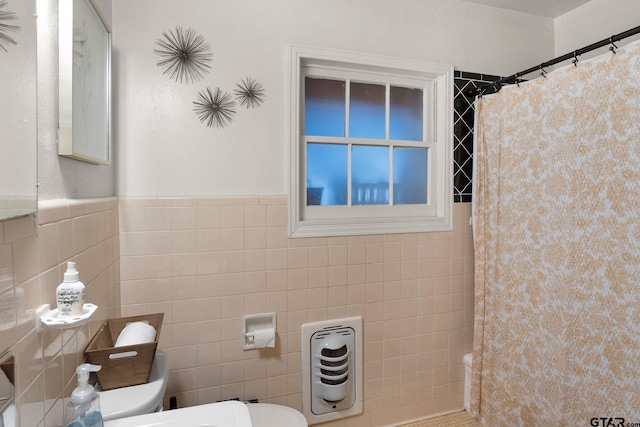 bathroom with tile walls, curtained shower, and toilet