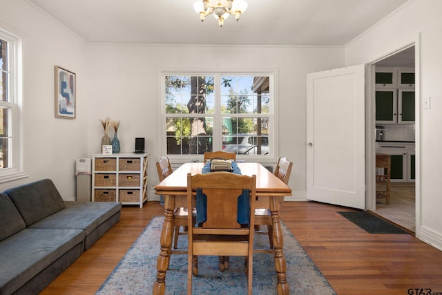 dining area featuring an inviting chandelier and dark hardwood / wood-style flooring