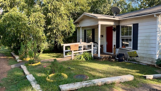 entrance to property featuring a lawn