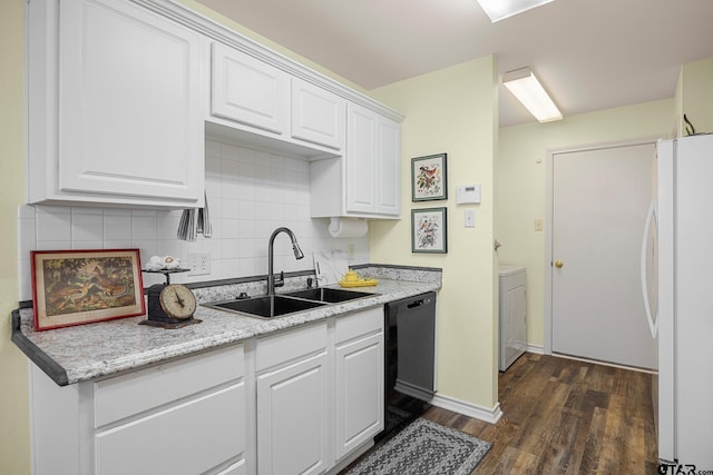 5401 Hollytree Dr, Tyler, TX 75703 - kitchen featuring freestanding refrigerator, black dishwasher, washer / clothes dryer, dark wood-style flooring, and white cabinetry
