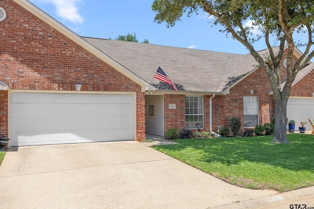 5401 Hollytree Dr, Tyler, TX 75703 - view of front of property with a shingled roof, brick siding, driveway, a front lawn, and an attached garage