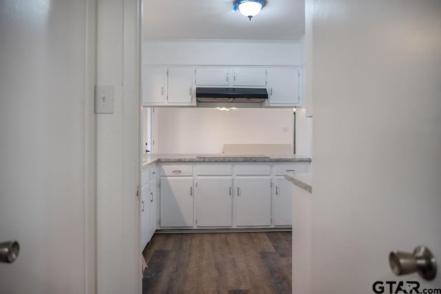 kitchen with dark hardwood / wood-style flooring and white cabinets