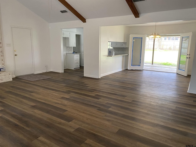 unfurnished living room featuring vaulted ceiling with beams, dark wood-type flooring, and a notable chandelier