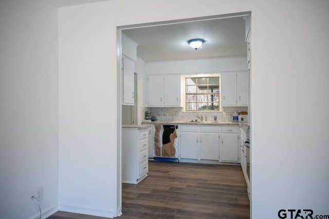 kitchen featuring sink, white cabinets, decorative backsplash, and dishwasher