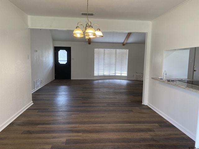 foyer entrance with dark wood-type flooring, a notable chandelier, and beam ceiling