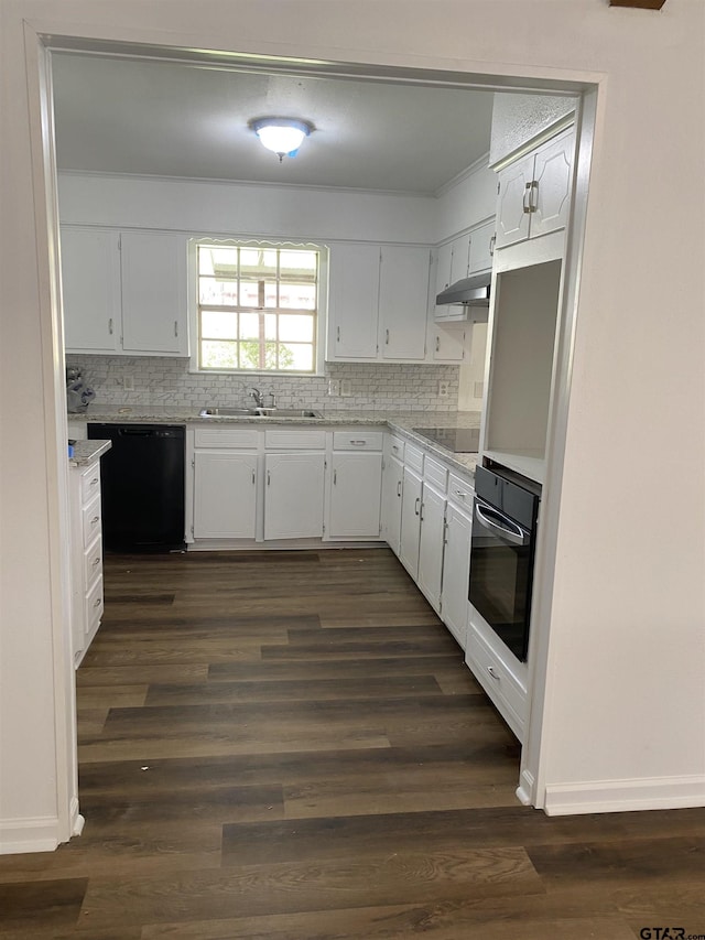 kitchen with white cabinets, tasteful backsplash, and black appliances