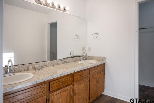 bathroom with hardwood / wood-style flooring and vanity