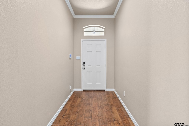 doorway with hardwood / wood-style flooring and ornamental molding